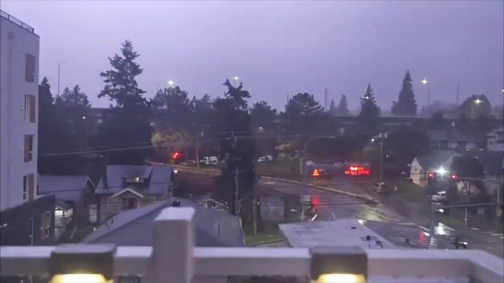 A video recorded in Seattle on Wednesday, March 26, shows lightning illuminating the sky during a thunderstorm.